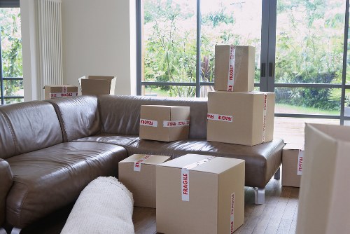 Furniture being carried through a shared building during a flat move